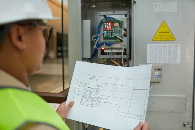 Female Worker Inspecting Electric Systems